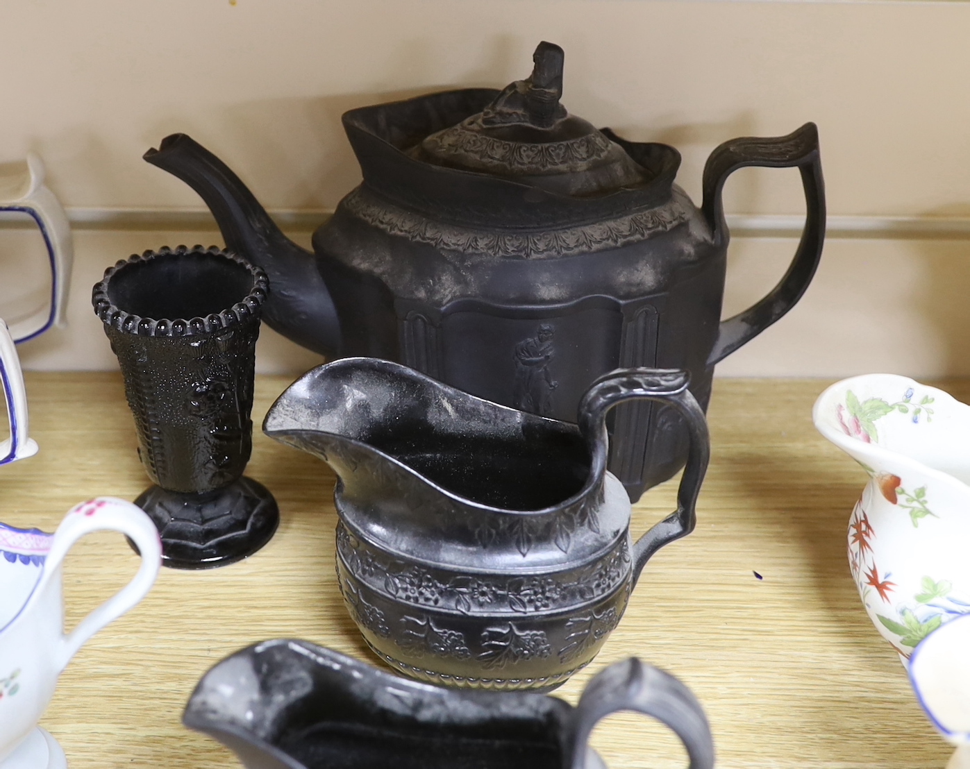 A collection of Regency stoneware and porcelain tea wares, including a small collection of black basalt, Castleford type etc. tallest teapot 17cm high